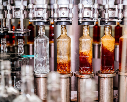 Alcohol Beverage Factory. Bottles On Conveyor Belt Of Bottle Filling Machine